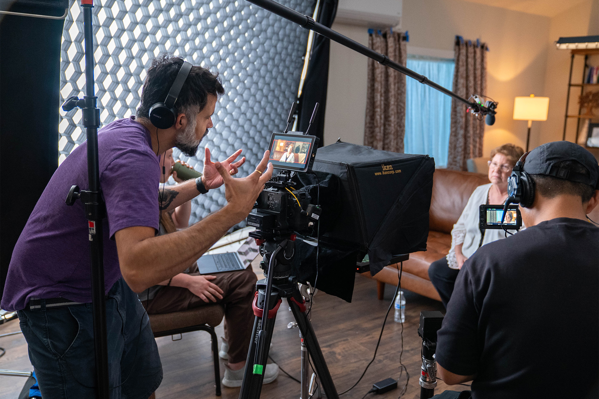 Neel Upadhye and a film crew interviewing Marlene Strege