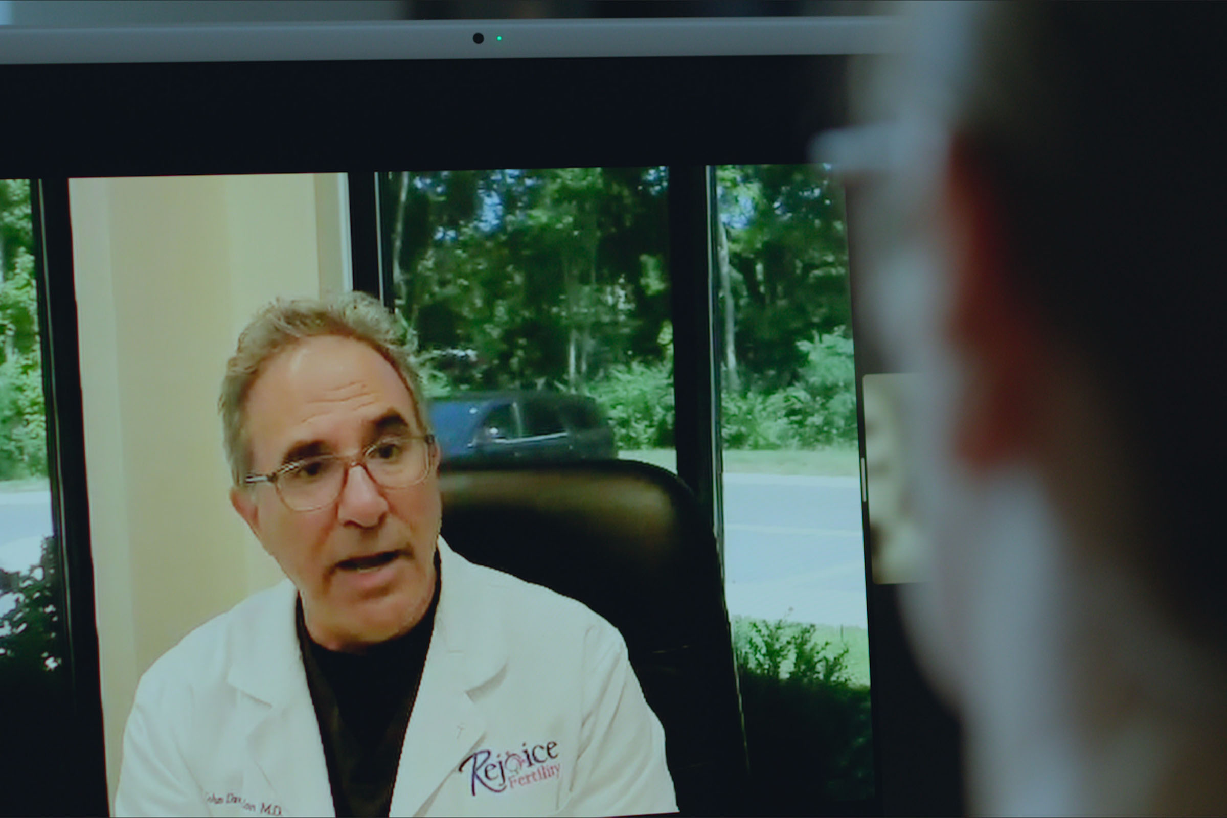 A woman speaks with a doctor over a video call